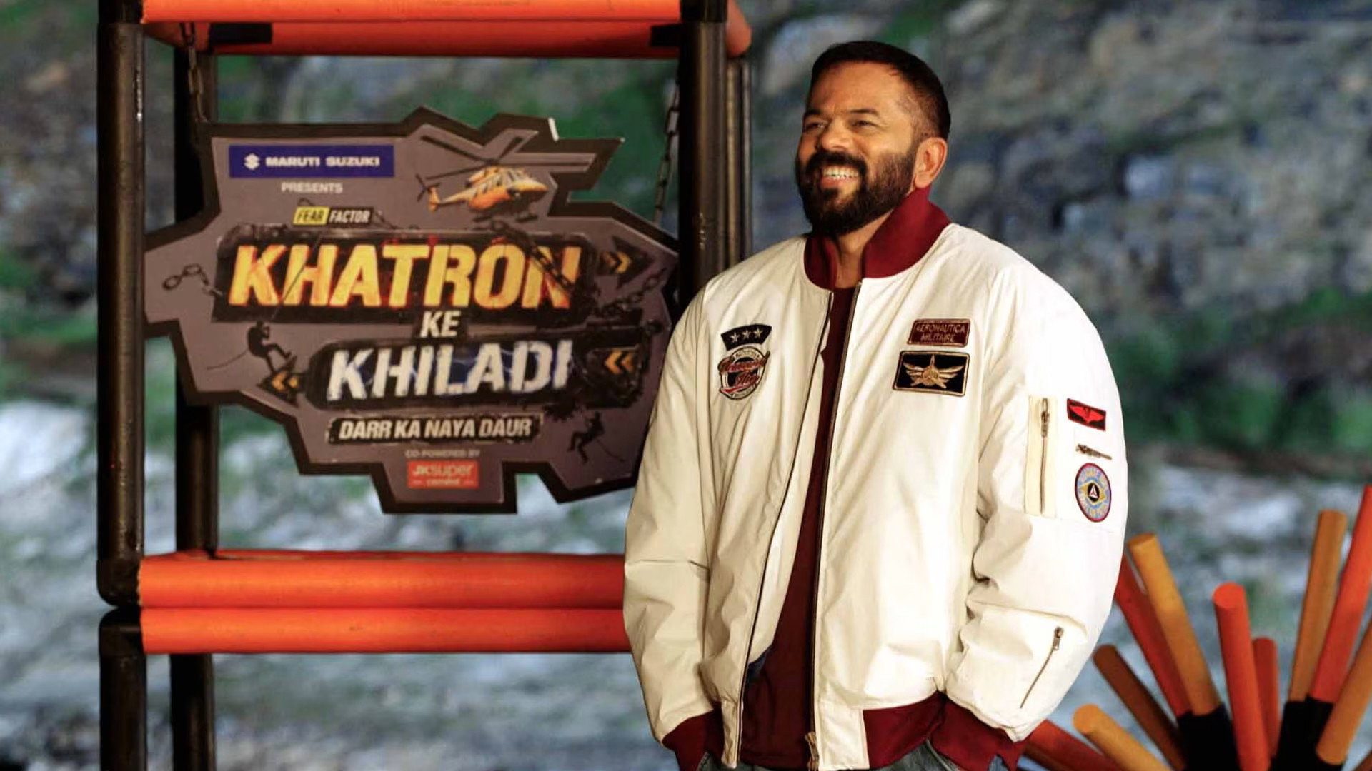 Rohit Shetty beside the Fear Factor Khatron Ke Khiladi title sign