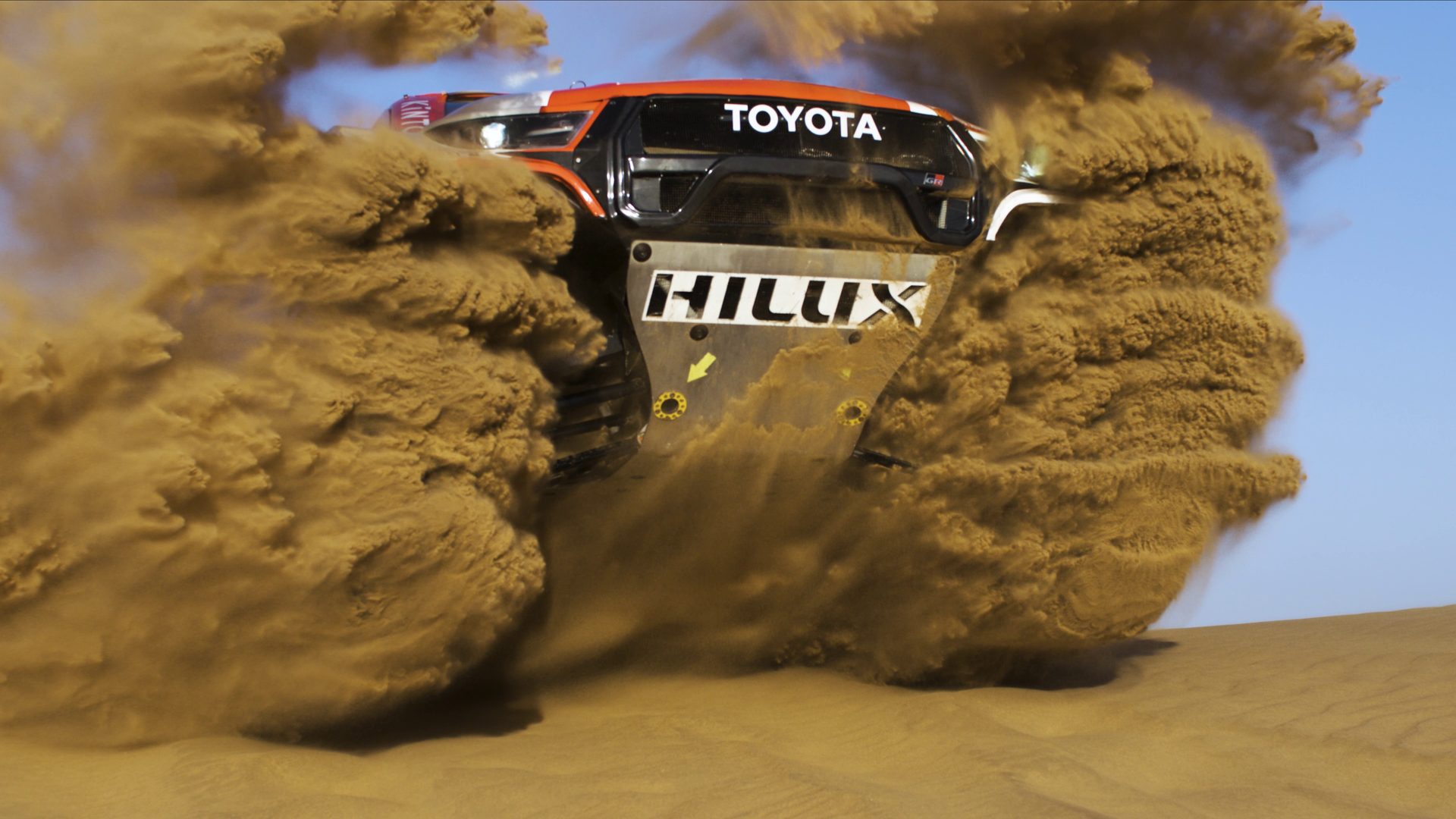 A Toyota Gazoo Racing Hilux Dakar at full speed through the Namib dunes, filmed from a gimbal stabilised FPV drone
