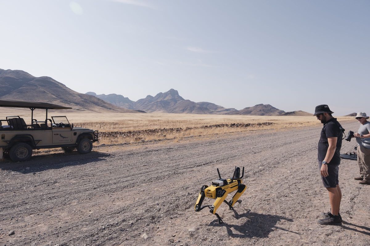 Dimitri Vaindirlis beside a Boston Dynamics Spot robot scanner on the NamibRand plains