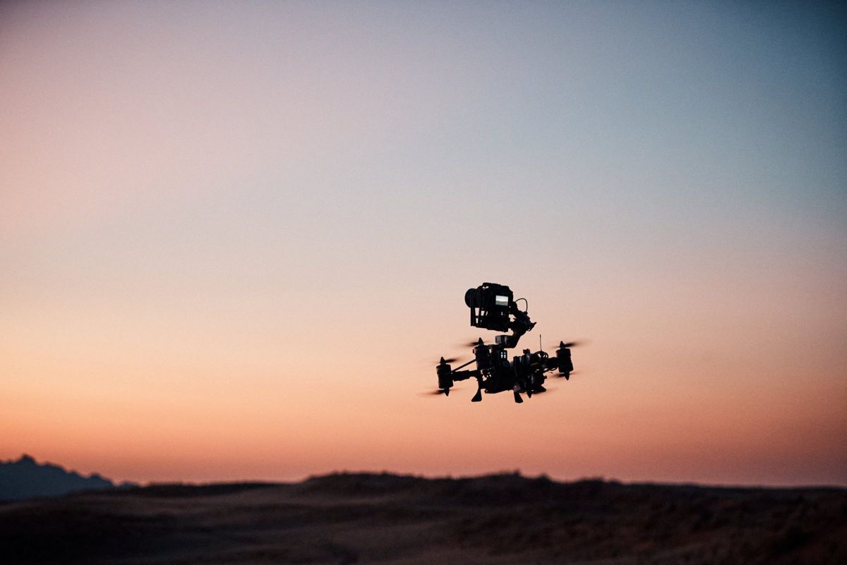Heavy lift gimbal FPV drone flying against the dusk sky over the Namib